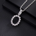 Macro view of silver round zircon pendant with intricate hollow design on rope chain - O-Silver