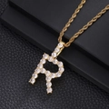 Macro view of iced out letter R pendant with cubic zirconia stones on gold rope chain - Letter R (Rope Chain) / Gold
