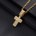Macro detail of gold-plated hip hop pendant with baguette-cut zircons and twisted rope chain - Letter T / Gold