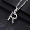 Macro shot of silver hip hop pendant with cubic zirconia letter R on rope chain - R-Silver