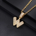 Macro detail of iced-out W pendant with cubic zirconia stones on black leather background - Letter W / Gold