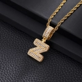 Macro view of gold Z-letter pendant with baguette and round-cut cubic zirconia crystals - Letter Z / Gold