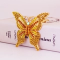 Anhänger Schmetterling in Gold mit gelben und orangen Strasssteinen auf weißem Hintergrund - Gold