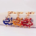 Three-piece Chinese dragon keychains in blue, gold, and red enamel for bags or keys - Random Color