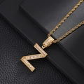 Macro shot of gold-plated letter N pendant with baguette and round cut cubic zirconia - Letter Z (5507837524637)