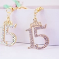 Sparkling crystal number 15 crown keychain accessory in gold finish for women - Random Color