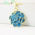 Sky blue enamel rose flower keychain with white rhinestones and golden metal clasp - Blue