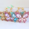 Colorful butterfly keychains with rhinestones in pink, blue, purple, and gold finishes - Random Color