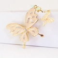 Sparkling rhinestone butterfly keychain with cream orange enamel and gold metal plating - Champagne