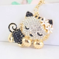 Sparkling rhinestone cute sleeping cat keychain with white flowers in gold finish - Black