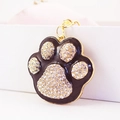 Cute black enamel paw print keychain with white crystals and golden metal ring - Black