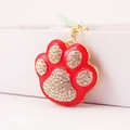 Red enamel paw print keychain with sparkling white rhinestones and gold metal finish - Red