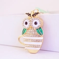 Creative owl keychain with rhinestones and green enamel on a golden base pendant - White