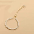 Detail of adjustable gold slider clasp and elegant white pearls on a minimalist bracelet - 5mm Pearl (SL0205-2)