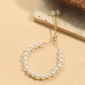 Detail of adjustable 14K gold plated pearl bracelet featuring a slider clasp and polished beads - 8mm Pearl (SL0205-4)