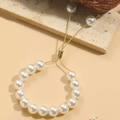 Close-up of adjustable 14K gold plated bracelet with white pearls and slider clasp - 10mm Pearl (SL0205-5)