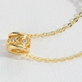 Elegant gold necklace with cylindrical zircon pendant on white leather surface - Cylindrical Hollow (Gold)