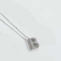 Macro view of silver letter B pendant with shimmering stones on a fine chain - Letter B