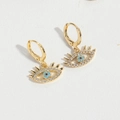 Golden Evil Eye huggie earrings featuring blue crystal charms and micro-pave stones - Evil Eye (ES2724-5)