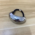 Minimalist elastic hair tie with polished silver metal accent on light wood surface - Silver