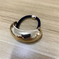 Retro golden C-shape metal hair tie with high elastic black rope on wood desk - Gold