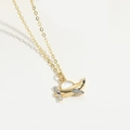 Detail shot of golden airplane pendant with iridescent mother of pearl and zircon stones - Airplane