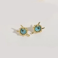 Golden copper stud earrings featuring blue resin evil eye charms in asymmetrical frames - Multi-Layer Evil Eye (MA1-4)