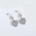 Close-up of silver heart dangle earrings featuring pave-set crystals and geometric link - Heart Style / Silver Heart