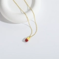 Golden fine chain necklace featuring a colorful capsule pendant with candy sprinkles finish - Cake Shape