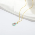 Primer plano de colgante de gota de agua con gema rosa y esmalte azul en cadena dorada - Azul