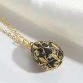 Vintage black enamel egg pendant with gold floral pattern and white crystals - Black