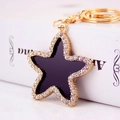 Star-shaped keychain with black enamel, sparkling rhinestones and gold plating - Black and Gold (Main Image Color)