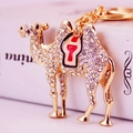 Creative camel keychain in gold metal with white rhinestones and enamel saddle detail - Red