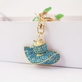 Cute golden hat keychain with blue rhinestones and pearl detail for women bags - Blue