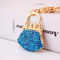 Blue rhinestone handbag keychain with golden alloy frame and sparkling crystal accents - Blue