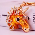 Porte-clés licorne en cristal scintillant avec émail orange sur métal doré - Doré