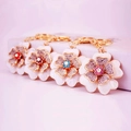 Charming gold alloy flower keychains with rhinestones and white enamel in four colors - Random
