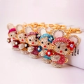 Portachiavi scintillanti stile Hello Kitty in cinque colori con ganci dorati - 11.6x4cm / Colore Casuale