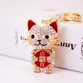 Golden lucky cat keychain with sparkling crystals and red lucky coin charm - Purplish Red