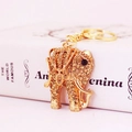 Lussuoso portachiavi a forma di elefante dorato con strass ambrati su libro - Oro