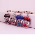 Set of four crystal-encrusted poodle keychains in black, blue, red, and iridescent colors - Random Color