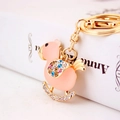 Pink rocking horse keychain with crystal rhinestones and gold plating on books - Peach