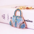 Portachiavi a borsa dorato con strass blu e motivi geometrici vintage di eleganza - Blu