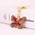 Colorful butterfly keychain with rhinestone crystal inlay on a golden alloy frame - Green and Peach