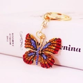 Sparkling rhinestone butterfly keychain in gold alloy finish with colorful crystals - Red and Golden Yellow