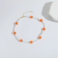 Detail van kralenketting met oranje vruchtenhangers en witte parels op witte achtergrond - Oranje (MA1-2)