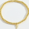 Elegant gold beaded bracelet with a minimalist letter F pendant for a personalized look - Letter F