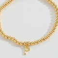 Minimalist gold beaded bracelet featuring a polished metallic capital letter P pendant - Letter P
