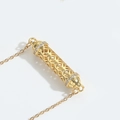Elegant gold hollow cylinder pendant necklace with sparkling zircon accents on edges - White Zircon