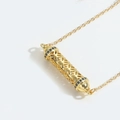Golden necklace with hollow cylinder pendant featuring black cubic zirconia accents - Blue Zircon